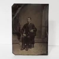 Antique Tintype Photo Man Sitting on a One Armed Chair: Front - Click to enlarge
